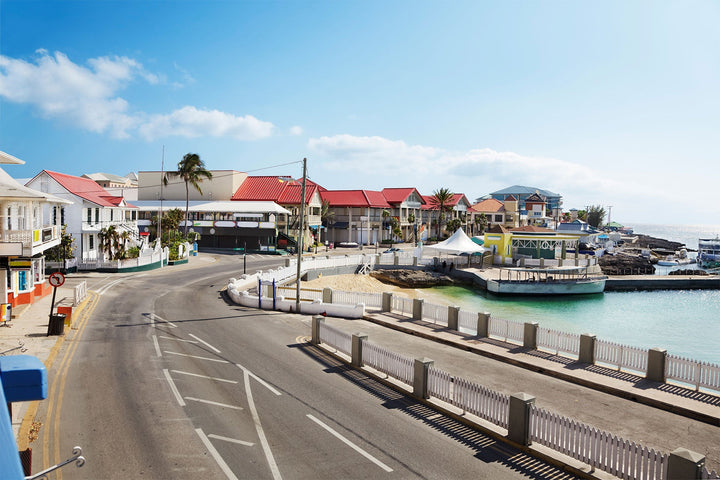 George Town waterfront in Grand Cayman, with colourful buildings and boats beside the harbour.
