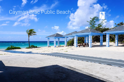 The scenic Cayman Brac Public Beach with gazebos, offering direct access to the clear Caribbean Sea for residents and visitors.